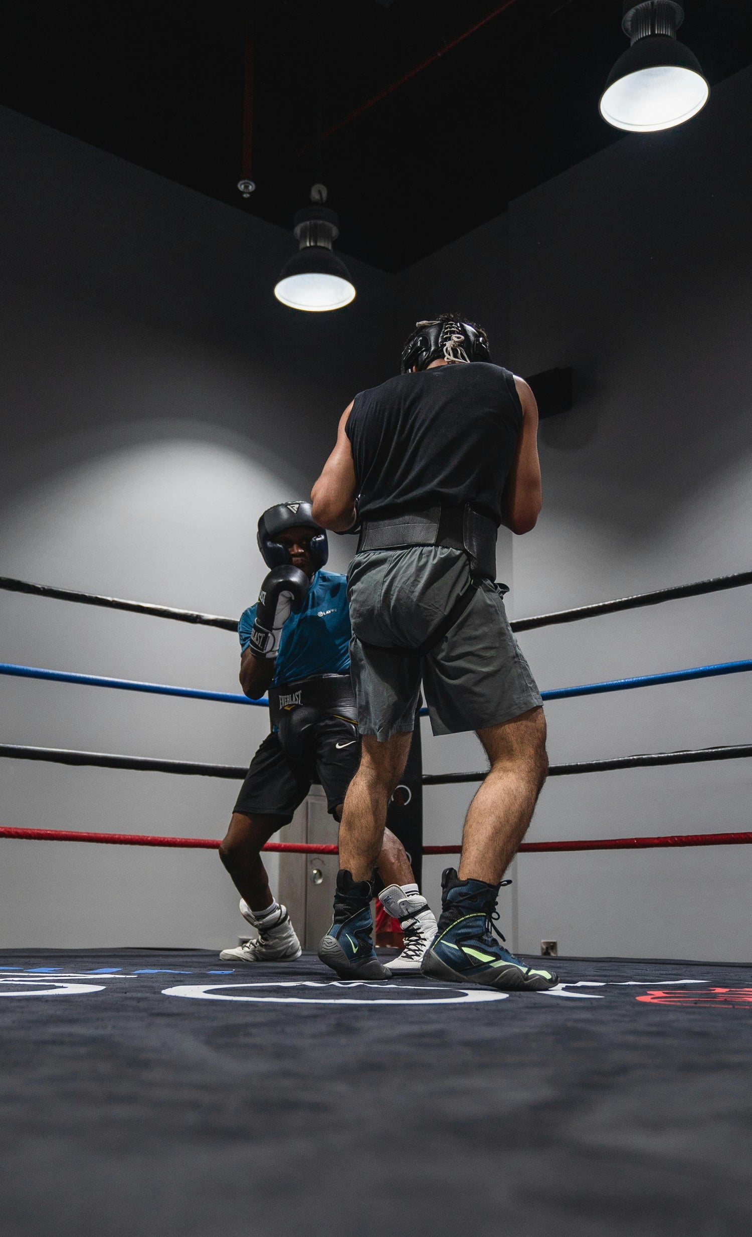 Two boxers sparring in a training ring wearing full boxing workout equipment—capturing the Fereli Code of discipline, edge, and elite preparation for the boxer champion mindset.