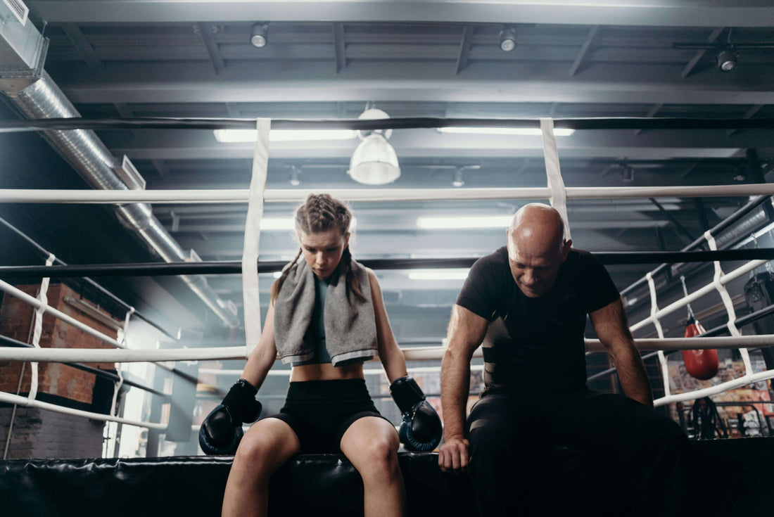 boxers resting in the ring after training highlighting boxing longevity and recovery importance