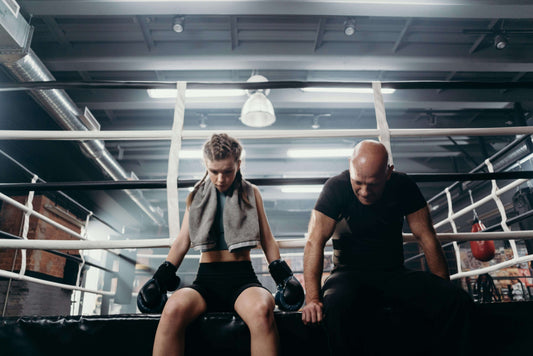 boxers resting in the ring after training highlighting boxing longevity and recovery importance
