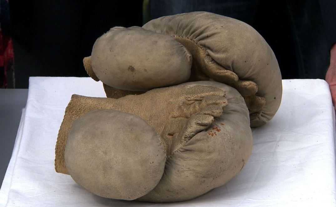 Pair of vintage leather boxing gloves known as mufflers, representing the first padded boxing gloves introduced in the 18th century.