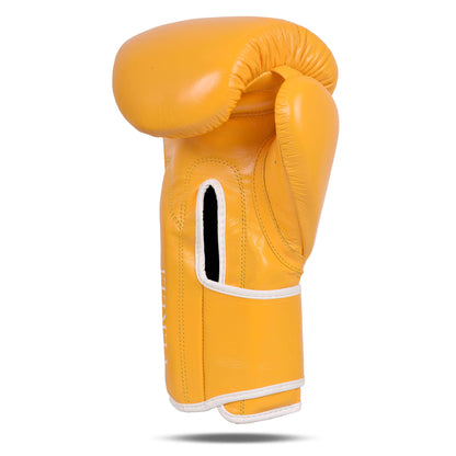 Side profile of the Fereli Emberlight leather boxing glove in yellow with white trim, showing the ergonomic shape, vented palm, and strap closure design.