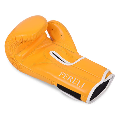 Angled view of the Fereli Emberlight yellow leather boxing glove showing the palm side and open strap, highlighting the craftsmanship and white contrast stitching.