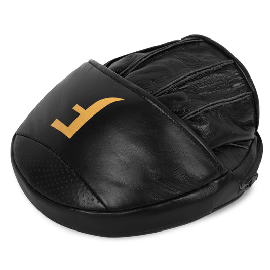 Angled view of Fereli focus mitts in black with gold branding – a powerful addition to any boxing clothes shop or precision training setup.
