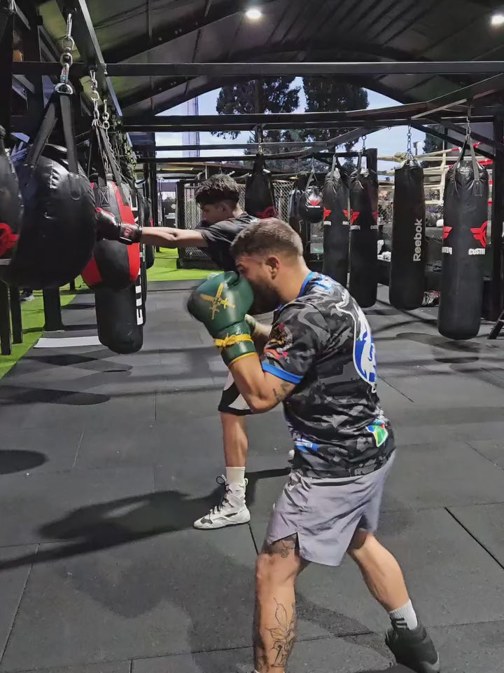 A professional boxer using Fereli Dastan boxing gloves for training.